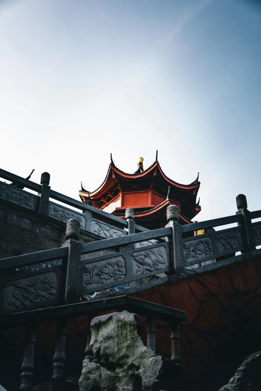 a stone lion statue sitting on top of a bridge, an album cover, inspired by An Zhengwen, trending on unsplash, red lanterns, roofs, hangzhou, architecture photo