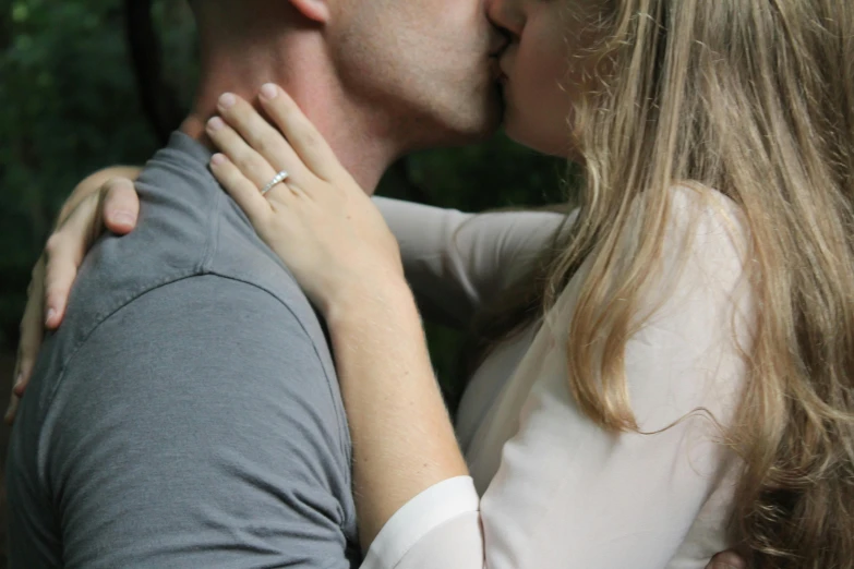 a man and a woman kissing in the woods, a picture, pexels, close up half body shot, grey, unedited, the ring