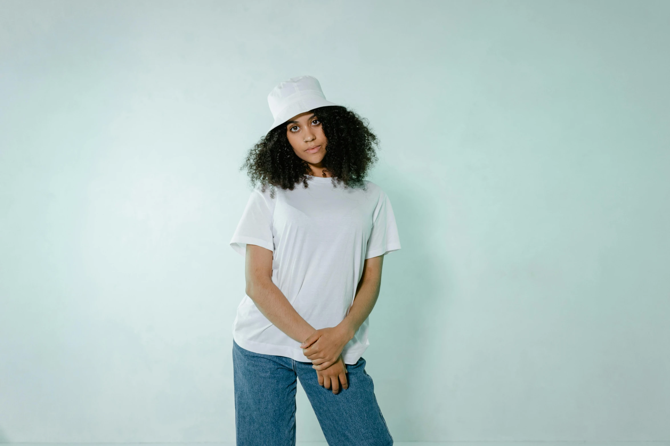 a woman in a white hat standing on a skateboard, by Nina Hamnett, pexels, minimalism, plain white tshirt, with afro, chef hat, promotional image