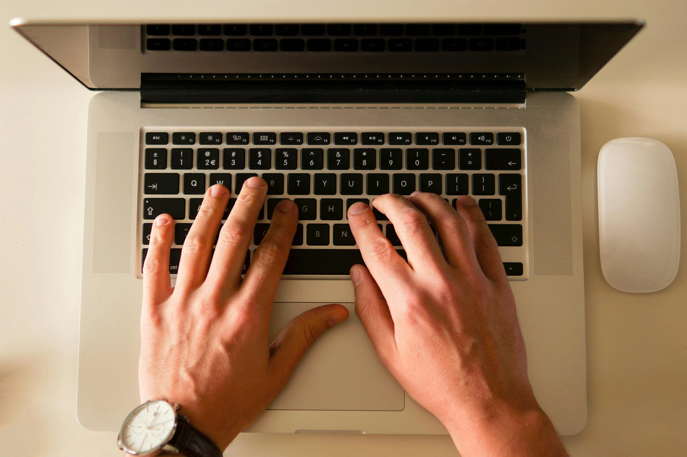 a close up of a person typing on a laptop, by Carey Morris, pexels, multiple stories, afp, bottom angle, a handsome