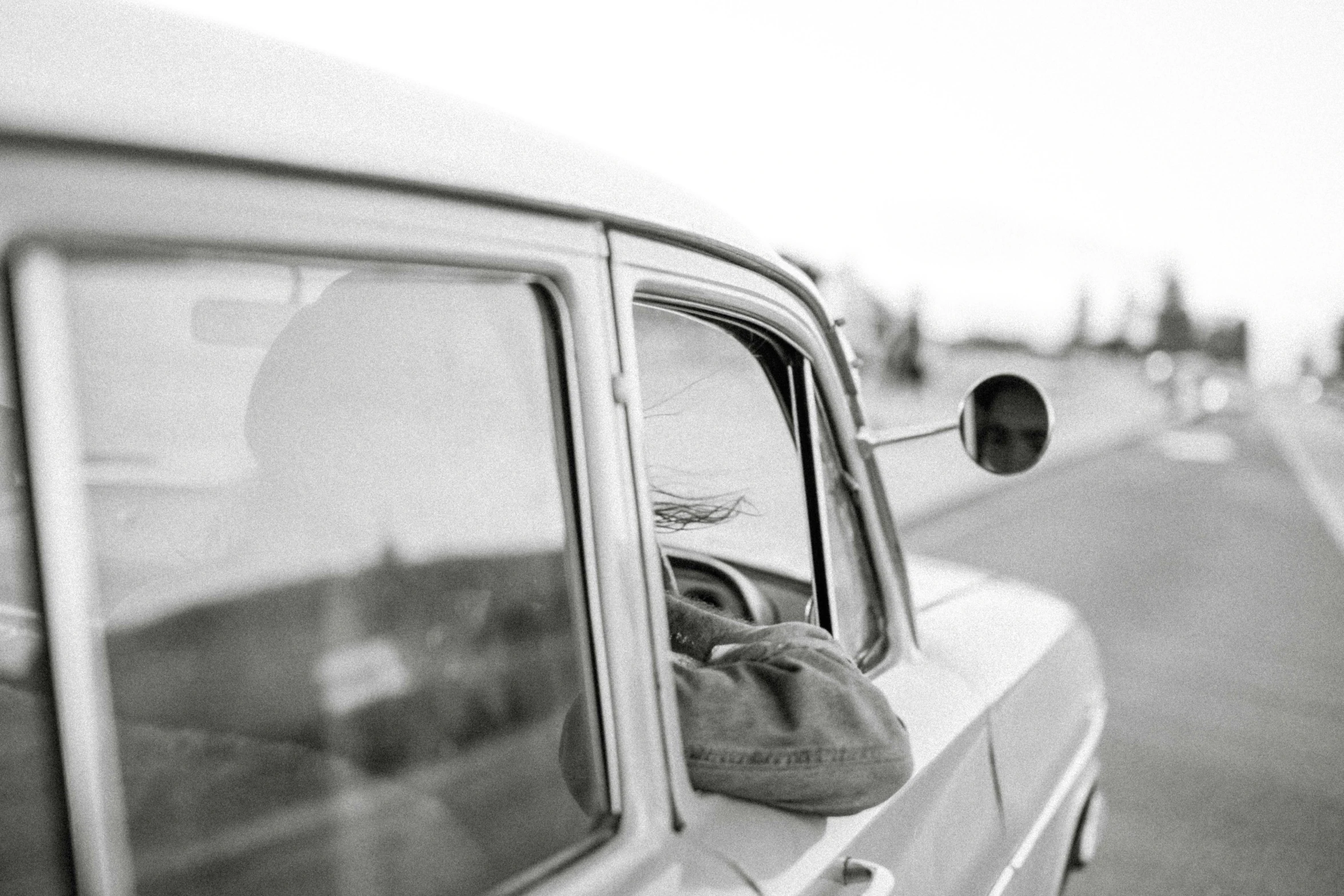 a black and white photo of a person in a car, vintage aesthetic, iceland photography, sideview, photo pinterest