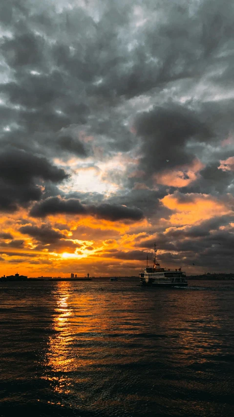 a large body of water under a cloudy sky, by Carey Morris, pexels contest winner, hurufiyya, new york harbour, amber glow, slide show, boat