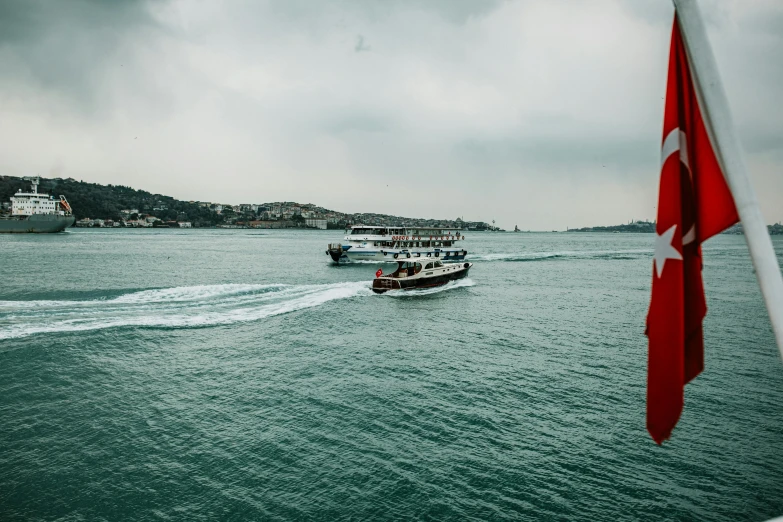 a couple of boats that are in the water, pexels contest winner, hurufiyya, turkish and russian, thumbnail, slight overcast, 🚿🗝📝