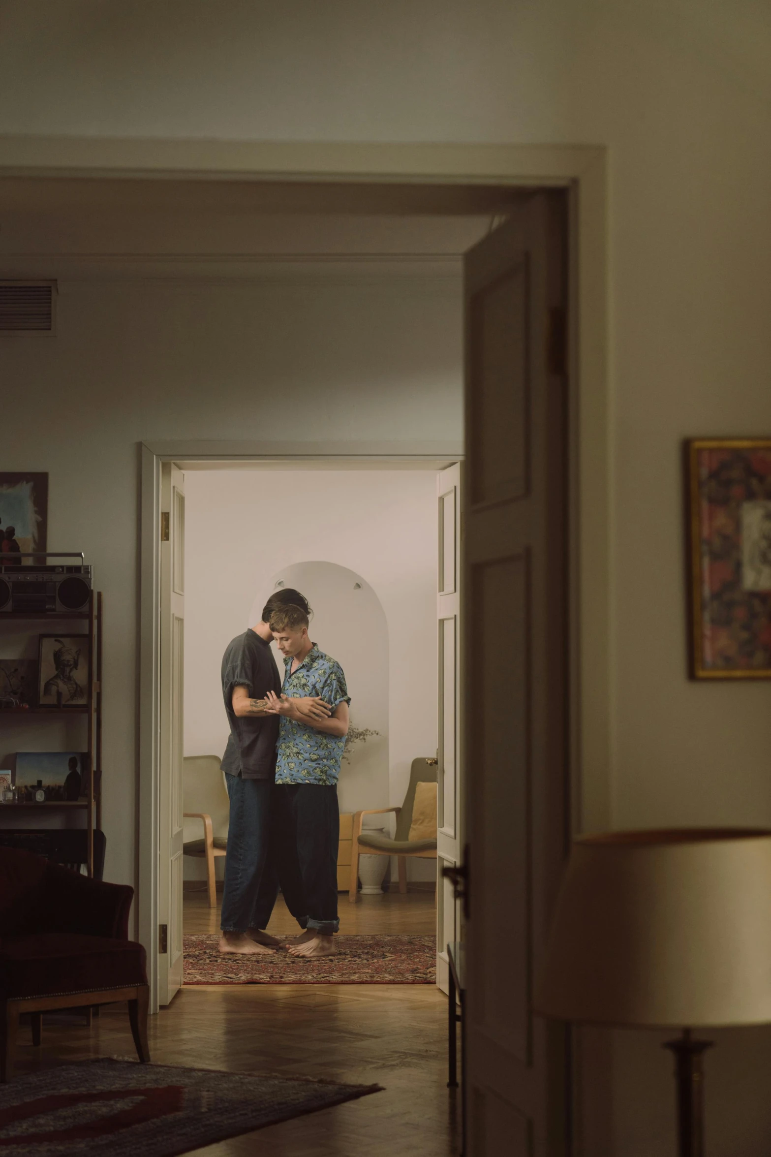 a man and a woman standing in a living room, hyperrealism, cinematic movie photograph, two men hugging, turkey, hallway