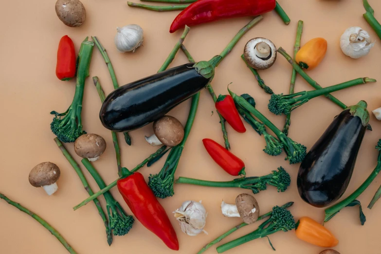 a table topped with lots of different types of vegetables, a still life, trending on pexels, background image, spicy, black, mushrooms grow from the body