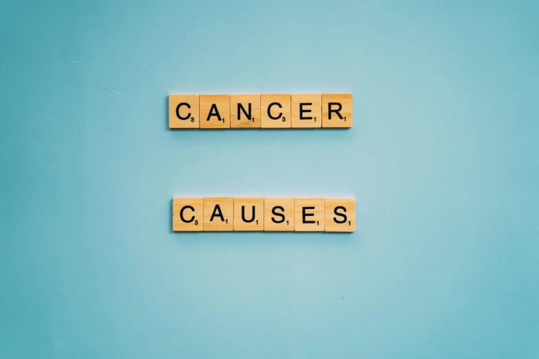 wooden blocks spelling cancer and causes on a blue background, by Ellen Gallagher, pexels, graffiti, in a dark teal polo shirt, whirling gasses, - 12p, then another