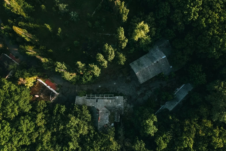 an aerial view of a house in the woods, a screenshot, pexels contest winner, empty buildings with vegetation, soviet yard, school, low-angle shot