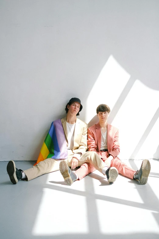 two people sitting next to each other in a room, an album cover, by Tadashi Nakayama, unsplash, gay pride, cute boys, bright white light, colorful]”