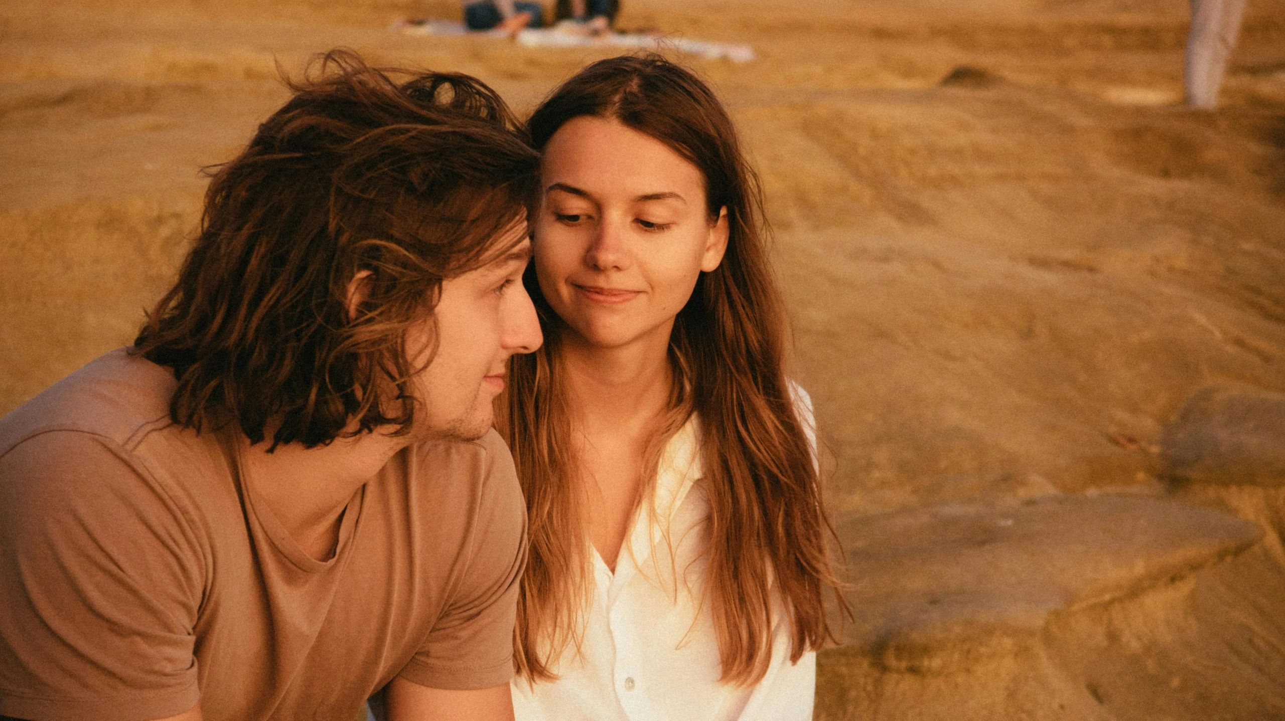 a man and a woman sitting next to each other, trending on pexels, frank dillane, golden-hour, mid long hair, romance