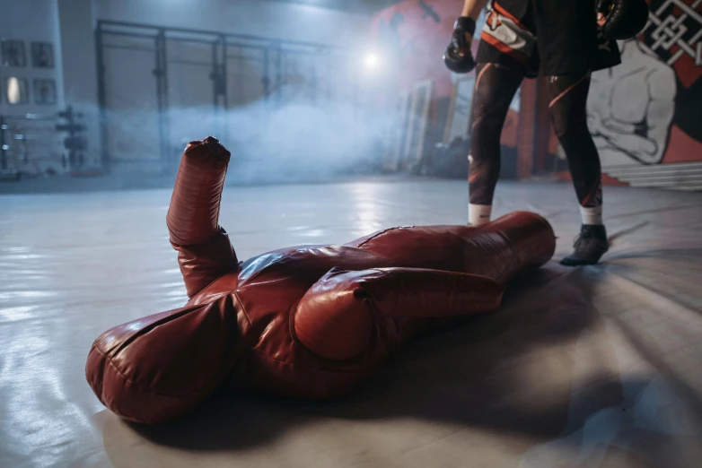 a pair of boxing gloves laying on the ground, pexels contest winner, figuration libre, red suit, indoor scene, people fighting, fuming effigy