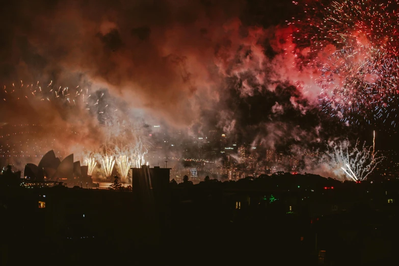 fireworks light up the night sky over a city, by Lee Loughridge, pexels contest winner, hurufiyya, sydney hanson, alessio albi, profile image, smokey cannons