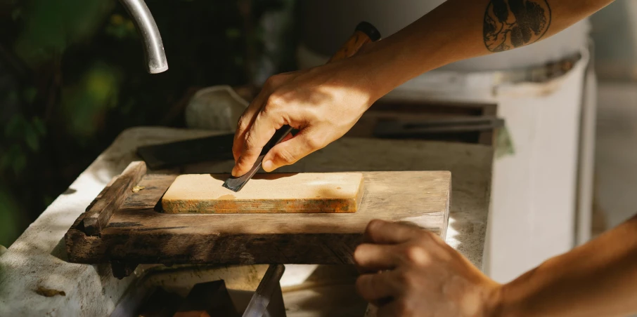 a person cutting a piece of wood with a knife, inspired by Kanō Shōsenin, trending on pexels, arts and crafts movement, rectangle, plating, thumbnail, petite