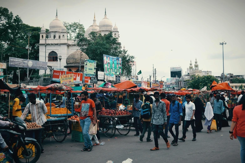 a group of people walking down a street, hindu aesthetic, square, cities, markets