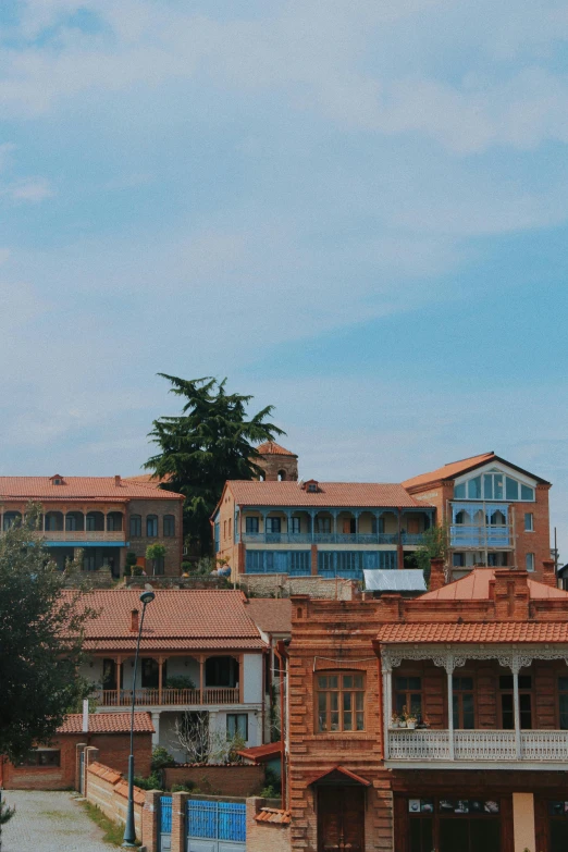 a group of buildings sitting on top of a hill, brick building, resort, ayanamikodon and irakli nadar, street view