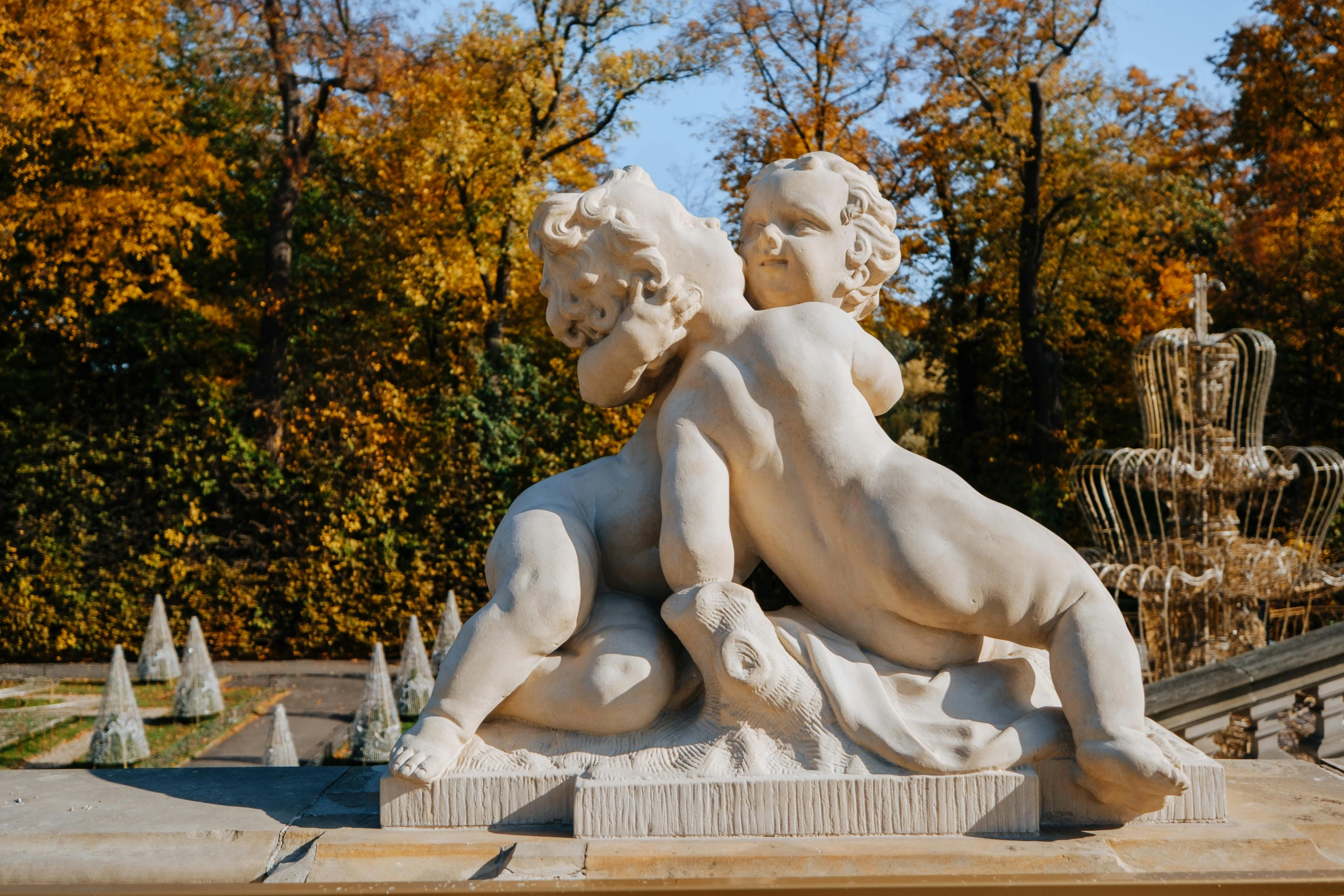 a couple of statues sitting next to each other, a marble sculpture, by Antoni Brodowski, pexels contest winner, in the autumn, putti, kissing each other, vista view