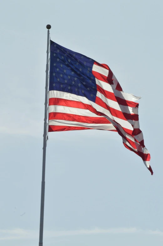 an american flag flying high in the sky, by David Simpson, square, in 2 0 1 5, high winds