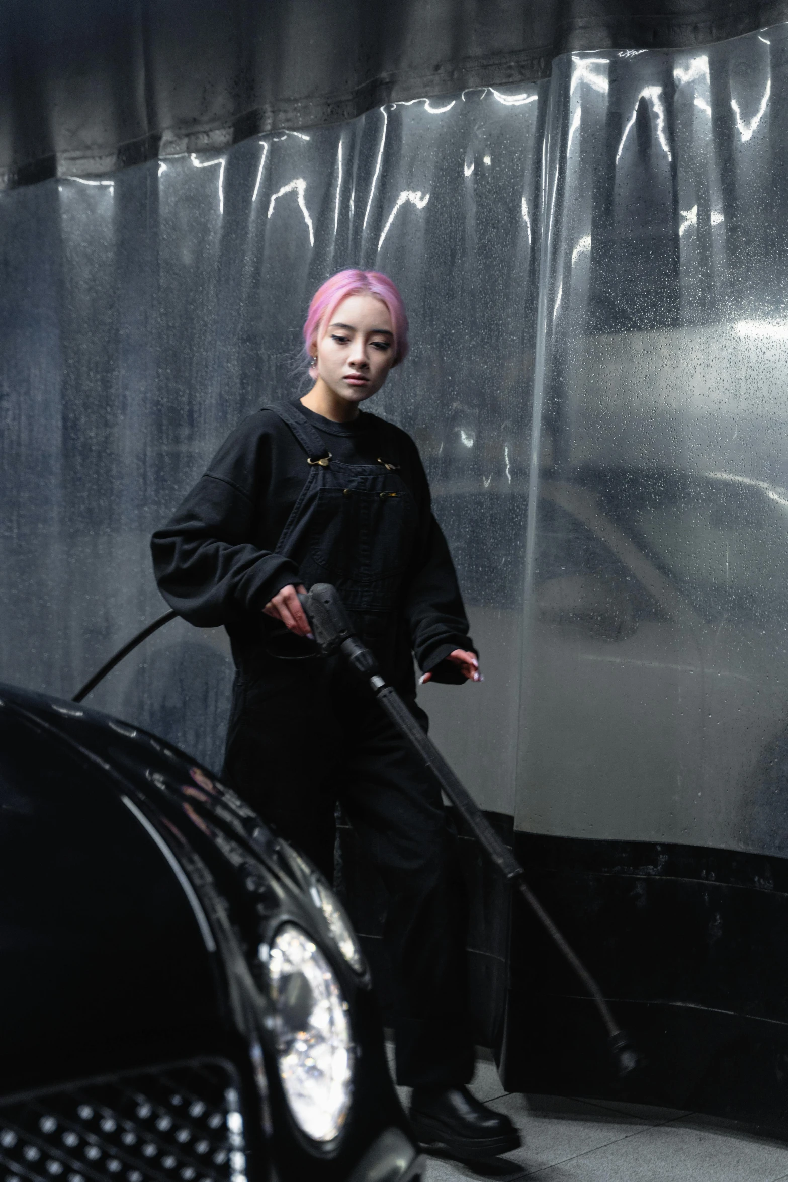 a woman with pink hair standing next to a black car, an airbrush painting, inspired by Zhang Xiaogang, unsplash, hyperrealism, hoses, work clothes, photographed for reuters, kiko mizuhara