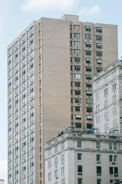 a couple of tall buildings sitting next to each other, by William Woodward, unsplash, modernism, neoclassical style, joel meyerowitz, three - quarter view, lower and upper levels