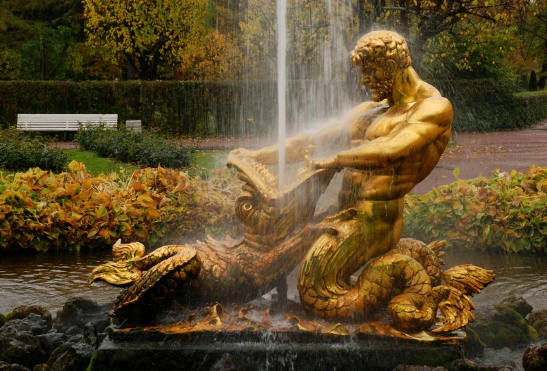 a golden statue sitting in front of a fountain, by Harry Haenigsen, pexels contest winner, serpentine water monster, during autumn, satyr, gardening