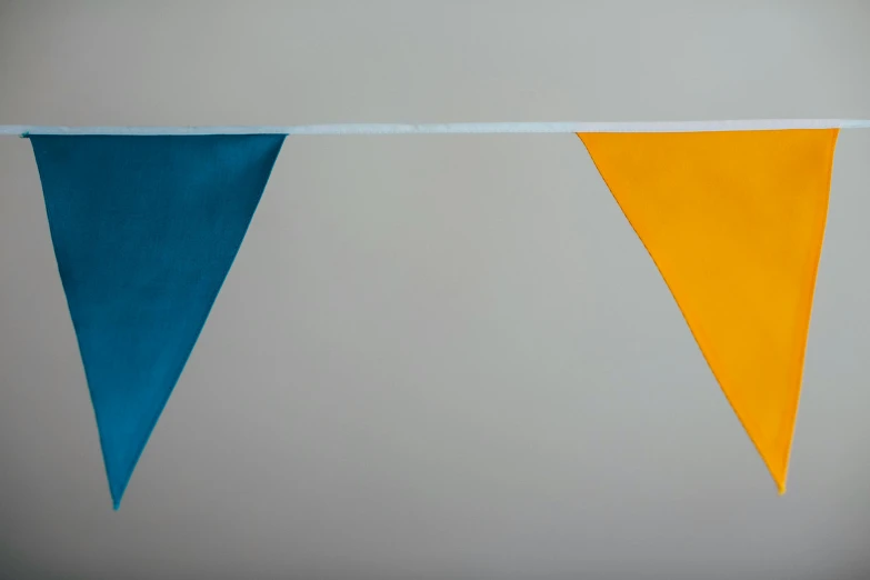 a couple of flags hanging from a rope, inspired by Christo, color field, prussian blue and azo yellow, teal and orange colours, medium close shot, on grey background