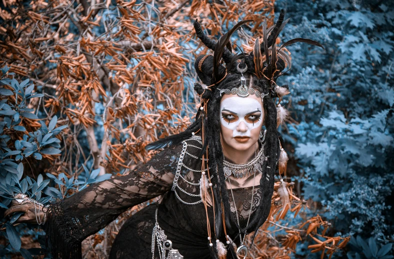 a woman in a black dress with horns on her head, pexels contest winner, autumnal empress, tribal clothing, /!\ the sorceress, scrap metal headdress