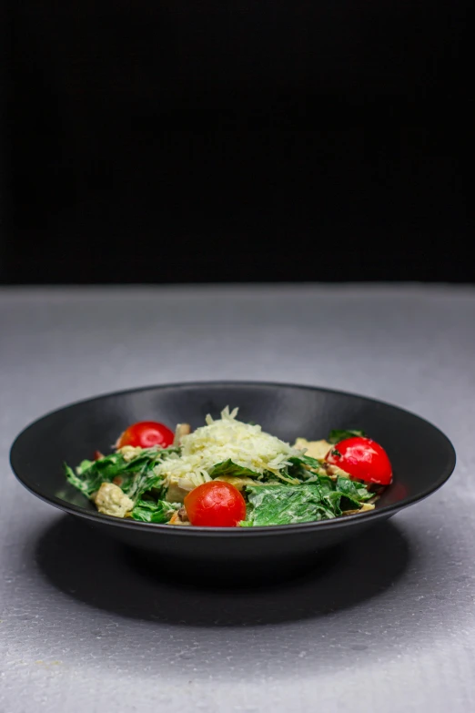 a close up of a plate of food on a table, in front of a black background, greens, detailed product image, bowl