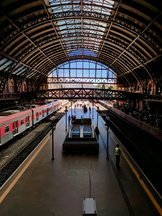 a train that is sitting inside of a train station, in the middle of the city, architectural photo, thumbnail, spanish