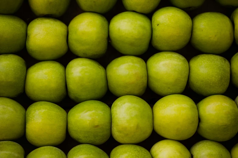 a pile of green apples sitting on top of each other, inspired by Elsa Bleda, unsplash, squares, tubes, manuka, close-up product photo