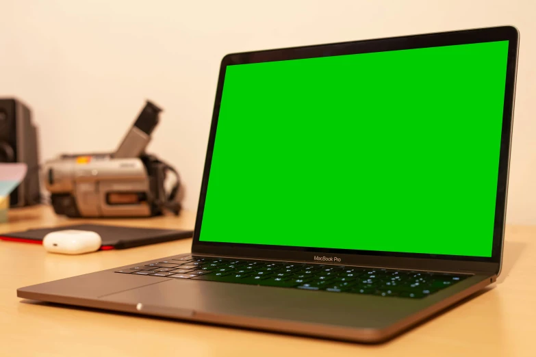 a laptop with a green screen is sitting on a desk, pexels, upscaled to 4 k, thumbnail, in a medium full shot, premium