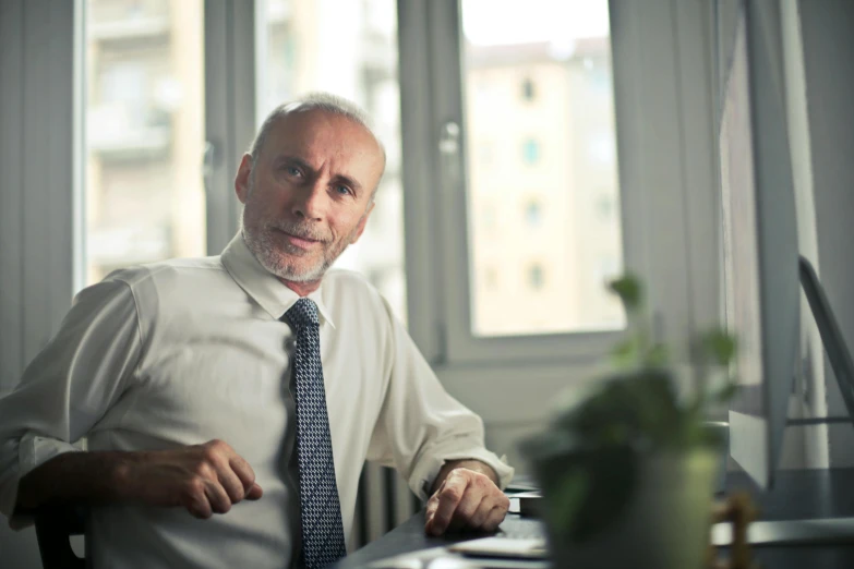 a man in a shirt and tie sitting at a desk, a photo, pexels contest winner, renaissance, mature male, lorenzo lanfranconi, avatar image, 5 0 years old man