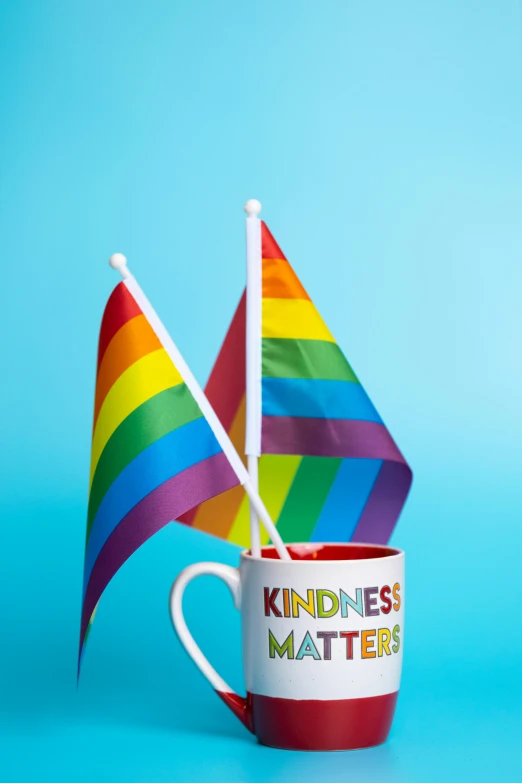 a cup with a rainbow flag sticking out of it, a picture, shutterstock, kindness, billboard image, brown, can