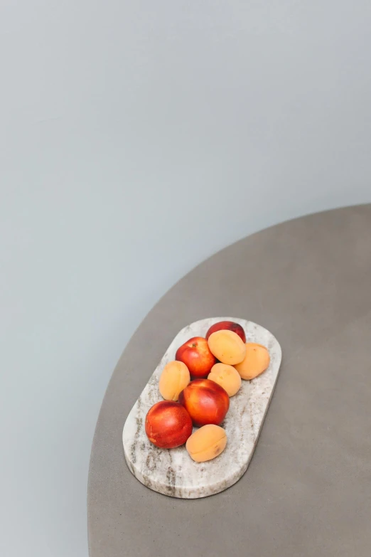 a close up of a plate of fruit on a table, by Harvey Quaytman, concrete art, peaches, light grey, rounded, ilustration