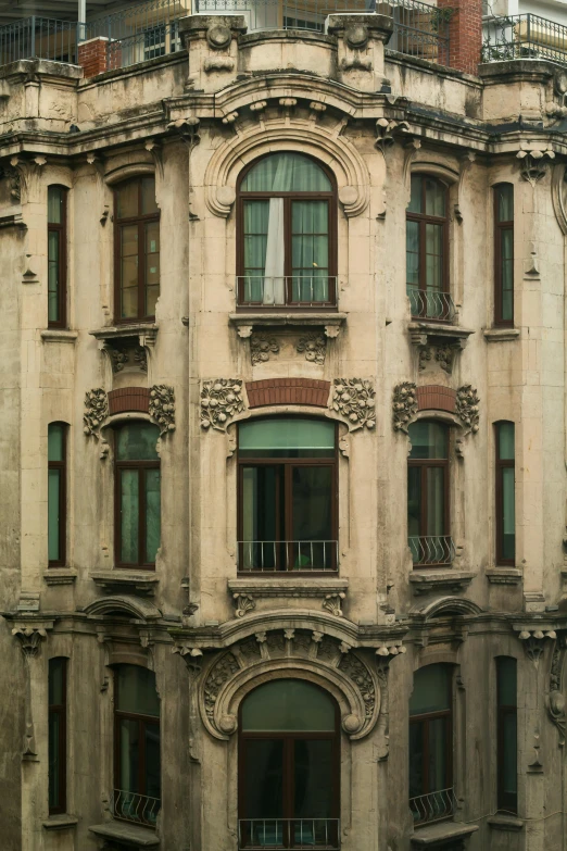 a tall building with lots of windows and balconies, pexels contest winner, art nouveau, istanbul, faded colors, art nouveau”