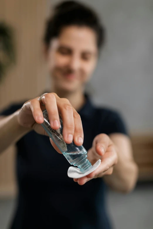 a close up of a person holding a cell phone, glassware, made of water