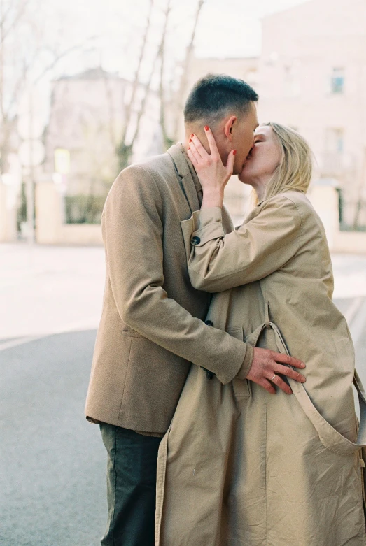 a man and a woman kissing on the street, light brown coat, non binary model, russian girlfriend, 6 : 3 0 am