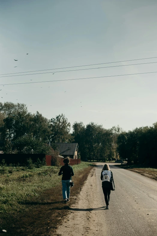 a couple of people walking down a dirt road, by Attila Meszlenyi, happening, small town surrounding, egor letov, high quality image, schools