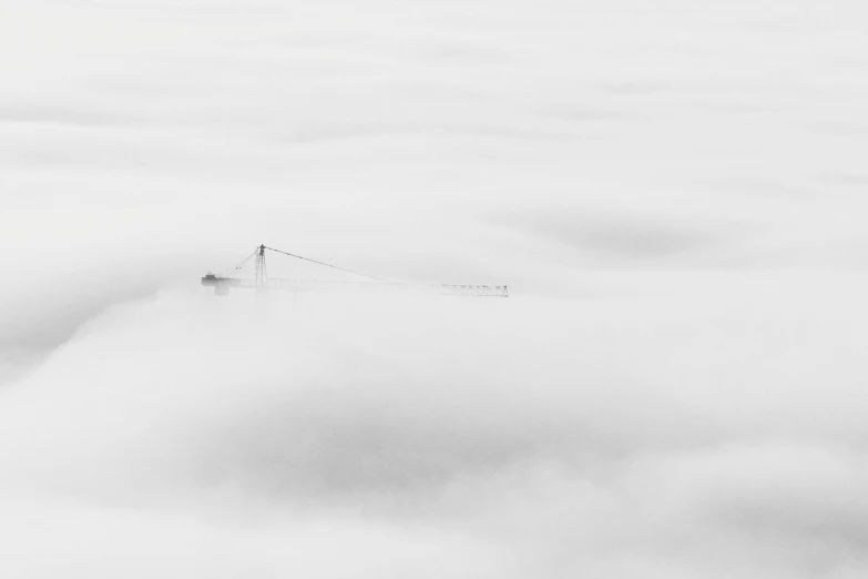 a black and white photo of a crane in the clouds, by Karl Buesgen, unsplash contest winner, minimalism, golden gate, cafe in the clouds, white mist, aerial photography
