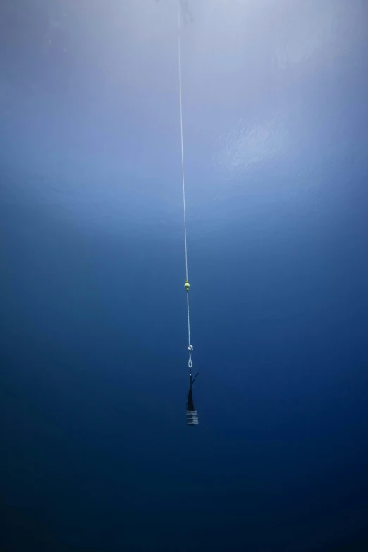 a boat that is floating in the water, hanging cables, bottom of the ocean, ultra long lens, iv pole