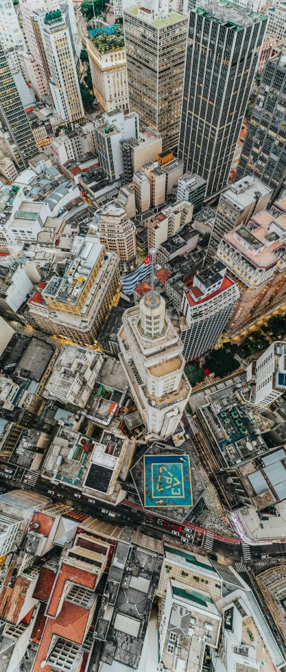 an aerial view of a city with lots of tall buildings, by Greg Rutkowski, pexels contest winner, instagram post, tall structures, flattened, auckland sky tower