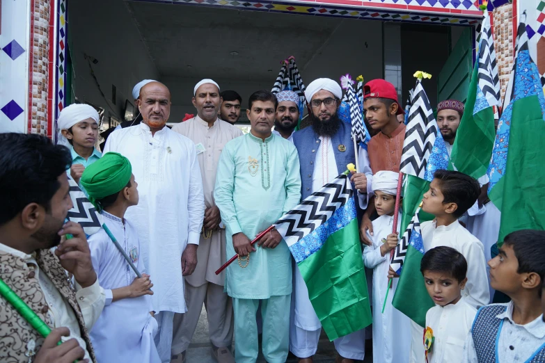a group of men standing next to each other holding flags, a picture, by Riza Abbasi, pexels contest winner, hurufiyya, green and white, deity), 2 5 6 x 2 5 6 pixels, innocent look