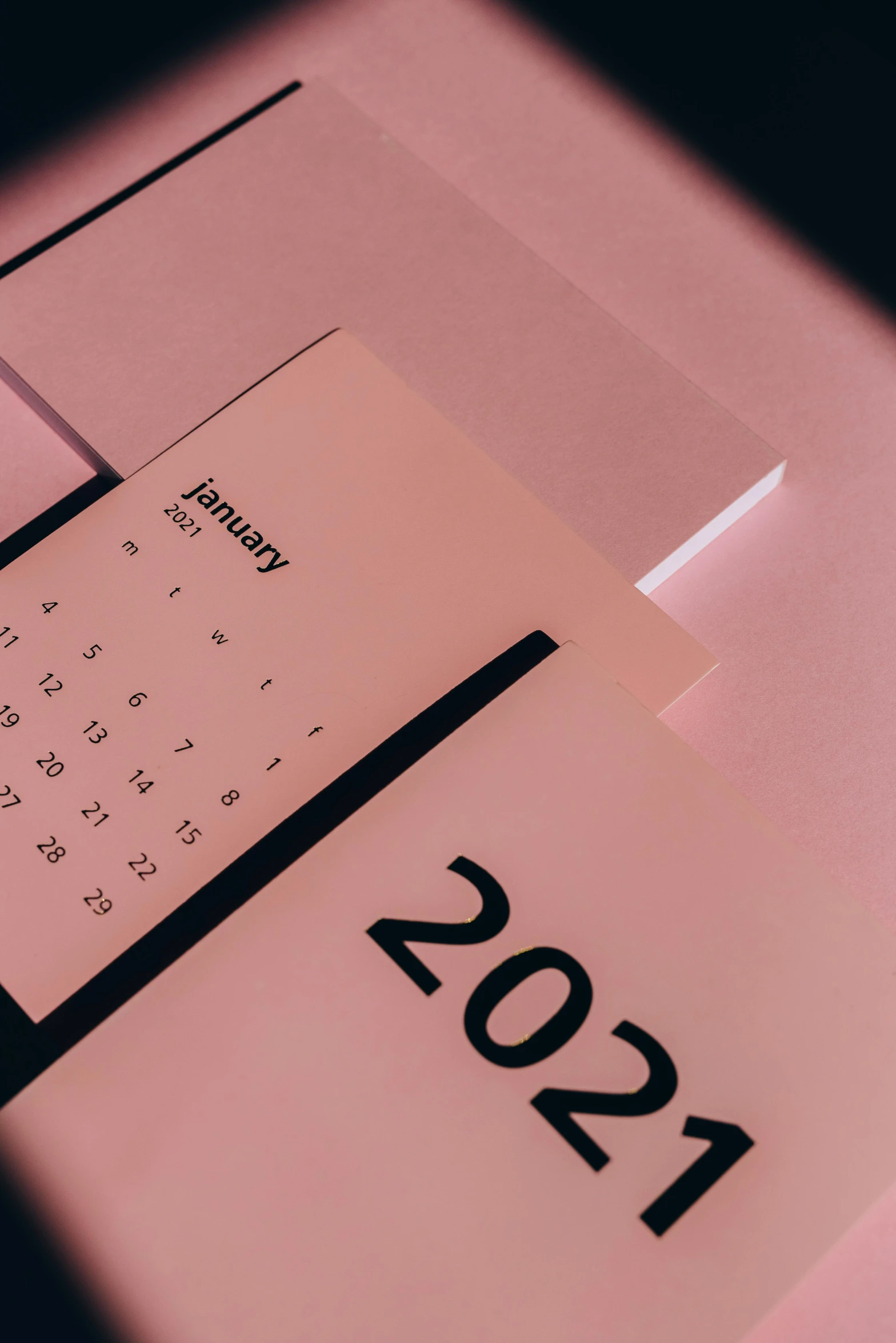 a close up of a calendar on a table, by Matija Jama, trending on pexels, happening, pink and black, thumbnail, year 2 0 2 2, glowing aesthetic