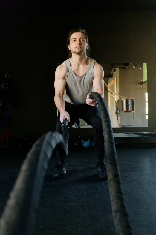 a man holding a rope in a gym, a portrait, pexels contest winner, rubber hose style, gif, caucasian, commercial photo