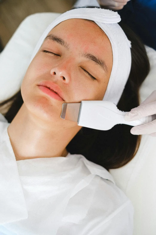 a woman getting a facial treatment in a beauty salon, a digital rendering, reddit, happening, square jaw, vibrating, brushed, manuka
