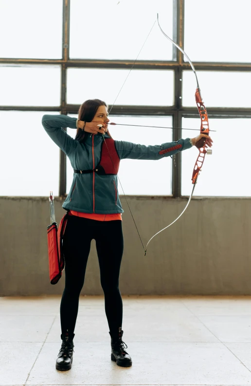 a woman holding a bow and arrow in front of a window, shutterstock, in the high school gym, red sport clothing, using a exoskeleton, promotional image