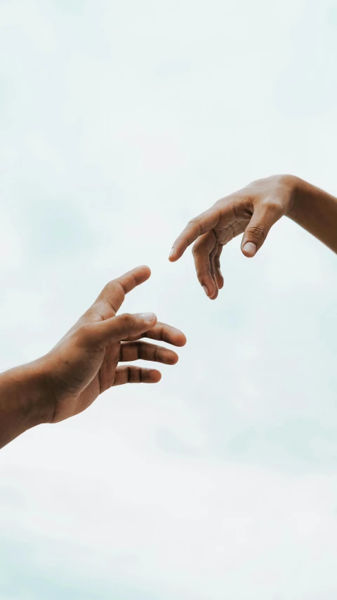 two hands reaching out towards each other, by Carey Morris, trending on pexels, calmly conversing 8k, on grey background, skies, integration