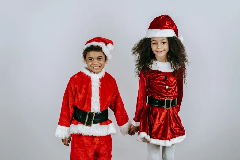 two children dressed up as santa claus and mrs claus, pexels, incoherents, diverse outfits, gif, bells, dressed with long fluent clothes