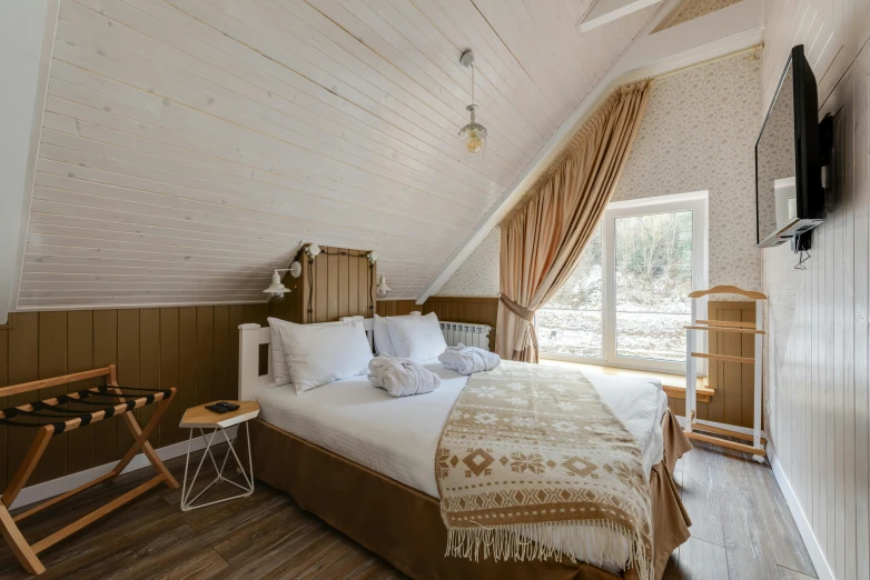 a bed room with a neatly made bed and a flat screen tv, by Julia Pishtar, unsplash, art nouveau, interior of a mountain hut, brown and white color scheme, turkey, slide show