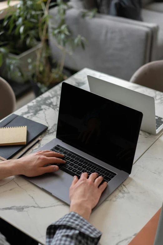 a person sitting at a table with a laptop, by Carey Morris, trending on pexels, rectangle, technical, covered, without text
