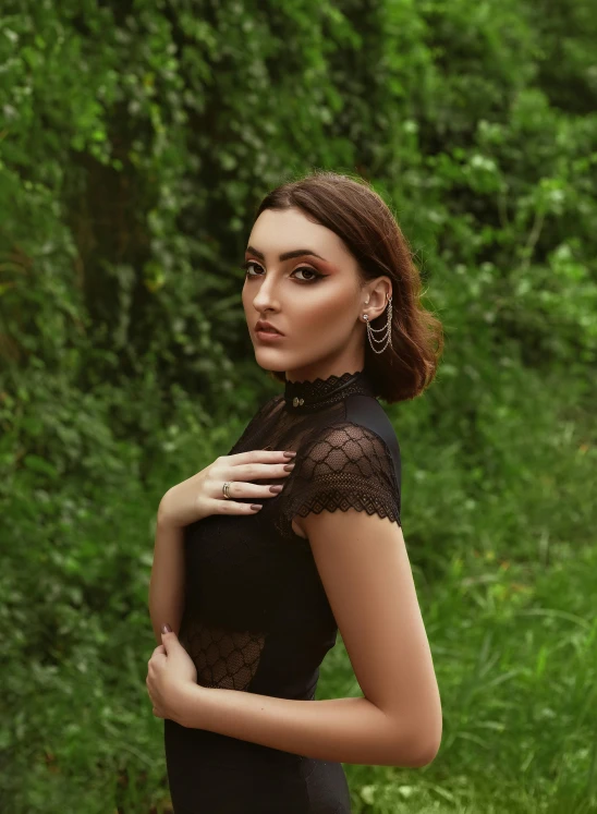 a woman in a black dress posing for a picture, an album cover, inspired by Elsa Bleda, trending on pexels, renaissance, greenery, profile image, amouranth, portrait sophie mudd