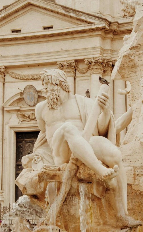 a statue of a man sitting on top of a fountain, by Gian Lorenzo Bernini, pexels contest winner, neoclassicism, square, man holding spear, low quality photo, conversano